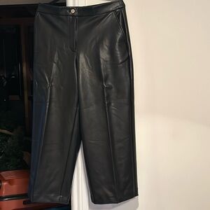 Black cropped wide leg faux leather pants with pockets. High waisted